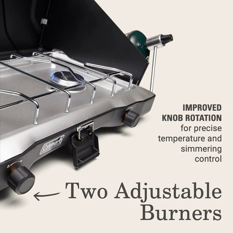 Close-up of Triton Two Burner Propane Camp Stove With Wind Guards showing adjustable knobs and durable chrome grate.