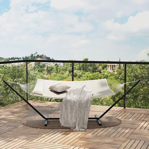 Two Person Outdoor Hammock With 12 Ft Steel Stand For Easy Setup No Trees Needed Portable Beach Patio Garden Chill Vibes 475 Lb Capacity Breathable Cotton Rope And Quilted Pad Weather Resistant Easy Fold Storage Case Included shown on a balcony.