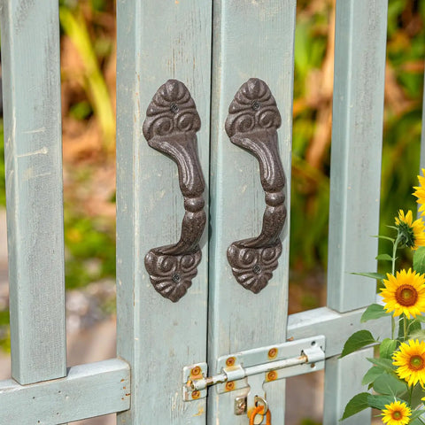 Vintage Cast Iron Door Handle Set 2 Pack Built Tough For Farmhouse Style Cabinet Pulls And Sliding Doors Fence Gates Cupboards Durable Antique Brown Finish attached to a blue gate with sunflower accents