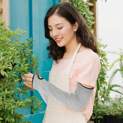 Woman wearing Industrial Grade White Cut Resistant Arm Sleeves Pro Level Forearm Protection For Welding Meat Processing And Auto Repair Tough As Nails Pe Guard Cover Set For Men And Women while gardening.