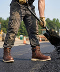 Men's Steel Toe Work Boots With Side Zipper, Water Resistant And Slip Resistant Safety Shoes, Electrical Hazard Rated, Heavy-Duty Construction Boots Built For Industrial, Outdoor And Warehouse Jobs in use during roadwork.