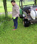 15 Gallon ATV UTV Spot Sprayer With 18 Inch Spray Wand, 12 Volt Diaphragm Pump, Filtration System, EZ Mount Quick Connect, No Shaft Or Seal Replacements, Translucent White Poly Tank For Lawn Care And Chemical Mixing. Man spraying grass from ATV-mounted translucent white poly tank