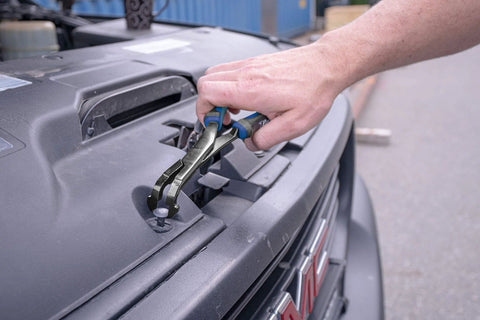 Person using 75 Degree U Joint Snap Ring Pliers Pro Grade For Automotive And Medium Duty Trucks Cars Equipment And ATV UTV Angled Push Pin Pliers For Use With Class 1 To 5 Vehicles 70301 on a truck engine