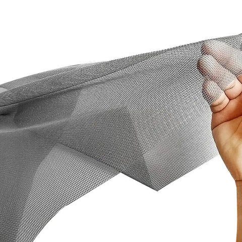 Hand holding gray mesh sheet of Adjustable 48 X 106 Fiberglass Window Screen Kit For Windows Doors And Patio DIY Pro Grade Replacement
