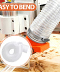 Two And A Half Inch By Three Foot Ultra Flex Puncture Resistant PVC Dust Collection Hose With Stainless Steel Clamps For Woodworking Shops Tough As Nails Ducting That Keeps Sawdust In Check attached to woodworking machine highlighting flexibility