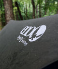 Logo on DryFly Rain Tarp Ultralight Hammock Shelter, water shedding polyurethane treated ripstop nylon in forest setting
