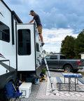 12.5 Foot Portable Aluminum Telescoping RV Ladder Heavy Duty, Rust Resistant, Fits Lippert On The Go Receiver, Easy Folding Design For Rooftop Access And Camp Life, man using RV ladder