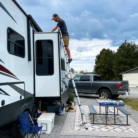 12.5 Foot Portable Aluminum Telescoping RV Ladder Heavy Duty, Rust Resistant, Fits Lippert On The Go Receiver, Easy Folding Design For Rooftop Access And Camp Life, man using RV ladder