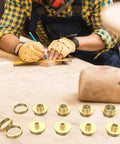 11-piece brass router template bushing set for 1/4 inch shank on a workbench