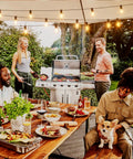 Outdoor String Lights 150 Ft With 75 Shatterproof G40 LED Bulbs 3 Spare Dimmable Warm White 2700K Waterproof Patio Cafe Backyard Market Lighting For Outdoor Parties Expandable Up To Six Strands illuminating a backyard dinner scene with people around a table and a grill.