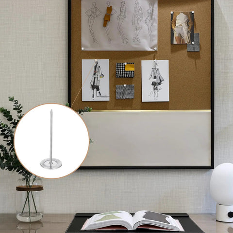 Hella Durable 15 Piece Long Upholstery Nail Set Packed With Heavy Duty Iron Flat Head Push Pins And A Slick Silver Finish displayed on a bulletin board.