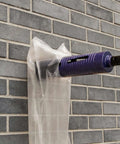 DaduoRi 2-in core drill bit with pilot and adapters, mounted on a drill against a brick wall, purple diamond segments.