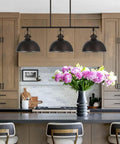 34 Inch Three Light Industrial Kitchen Island Pendant With Dome Shade Lighting Swivel Joints Brushed Nickel Finish Modern Farmhouse Style Chandelier hanging over kitchen island with flowers