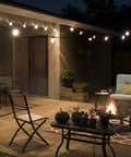 Backyard Bistro Style 24 Foot Outdoor String Lights With 12 Shatter Resistant Lifetime Bulbs illuminating a cozy patio area