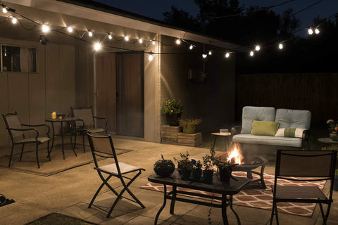 Backyard Bistro Style 24 Foot Outdoor String Lights With 12 Shatter Resistant Lifetime Bulbs illuminating a cozy patio area