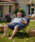 Man relaxing on Oversized Moon Chair For Camping And Outdoors Folding Padded Saucer With Side Pocket 500 Lb Capacity Heavy Duty Steel Frame.