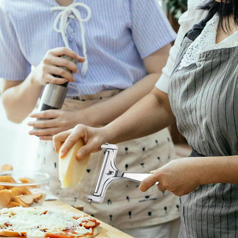 Adjustable Cheese Slicer With Four Replaceable Stainless Wires Heavy Duty Aluminum Alloy Handheld Cheese Cutter for block cheese in use.