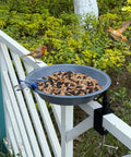 No Bull Fully Adjustable Deck Mounted Birdbath With Secure Grip Rail Clamps, gray bowl on railing with birds and seeds.