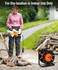 Person using chainsaw next to Extension Cord Storage Reel With Hand Crank, 4 Outlets, 15 Amp Overload Switch, Heavy-Duty Metal Stand.