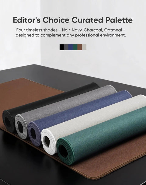Rolled large gaming mouse pads in various colors on display with non-slip rubber bases and edge stitching.
