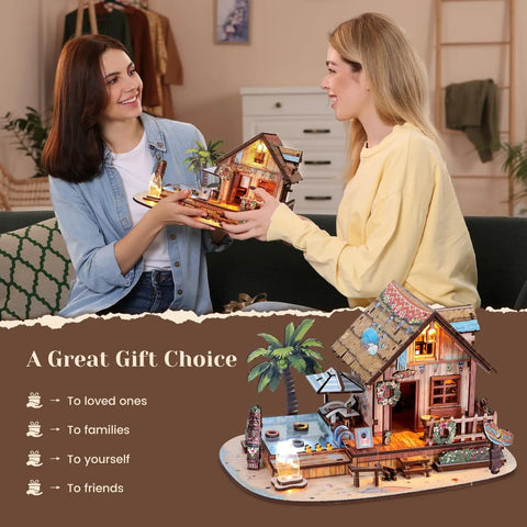 Two women admiring assembled Hawaiian Vacation Beach House 3D Wooden Puzzle Kit With LED Light For Adults, 187 Pieces DIY Model Building Kit.