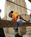 Construction worker wearing Atlas 300 Original 1994 Crinkle Grip Work Gloves With Natural Latex Palm Heavy Duty 10 Gauge Blue Large