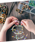 Hands crafting with colorful pentagram glass spacer beads in a jewelry making kit, perfect for DIY bracelet making.