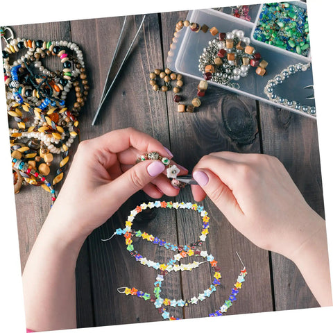 Hands crafting with colorful pentagram glass spacer beads in a jewelry making kit, perfect for DIY bracelet making.