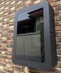 Hella Weatherproof EV Charger Enclosure Lockable Outdoor Box For Secure Electric Vehicle Cable Storage, black steel mounted on wall.