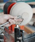 Heavy Duty 1 Inch Diameter Woodturning Lathe Tool Rest Set showing user shaping wood with a steel chisel on lathe.