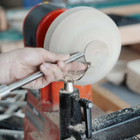 Heavy Duty 1 Inch Diameter Woodturning Lathe Tool Rest Set showing user shaping wood with a steel chisel on lathe.