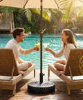 Rock Solid Heavy Duty Round Umbrella Base 85.7 Pound Water And Sand Filled Patio Stand beside pool with lounging couple