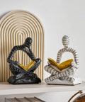 Heavy Duty Decorative Book Ends For Shelves With Thinker Statue Design in black and white on modern home office shelf.