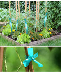 Ultra Stretch Garden Tie Tape 1 Inch Wide 200 Foot Reusable Green Plant Ties in greenhouse with tomatoes and wooden stakes.