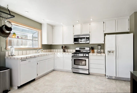 Modern kitchen with white cabinets, metal appliances, and ample lighting designed to fit Oil Rubbed Bronze Kitchen Cabinet Hinges One Half Inch Overlay