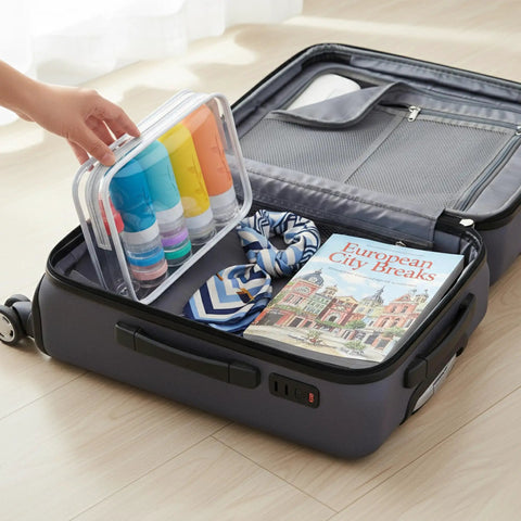 Open suitcase with Carry On Ready Travel Bottles Kit 16 Pack TSA Approved Leak Proof Silicone Squeezable Containers.