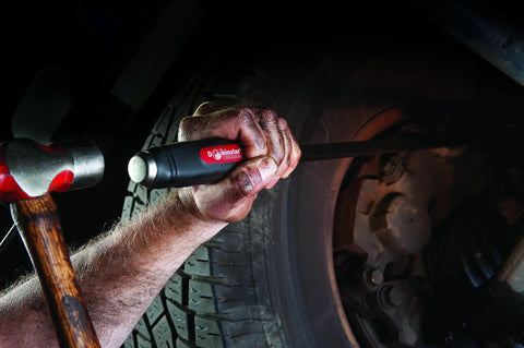 Dominator Pry Bar Set 25 Inch And 31 Inch Curved Black Oxide Finish being used for automotive repair in tight space with ergonomic handle.