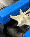 Heavy Duty Heat Resistant Magnetic Soft Jaws For Bench Vise Drill Press Clamps fitted on a workbench, securing a starfish.