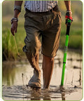 Person using Handy Tiny Garden Rake With Telescoping Handle 27 To 39 Inches Non Slip Grip in flower beds and tight spaces.