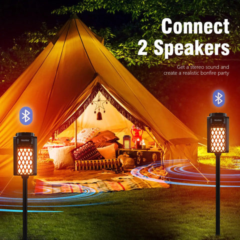 2-Pack Outdoor Torch Atmosphere Bluetooth Speakers, 10W Portable IP65 Waterproof LED Flame Lights in front of a lit tent
