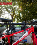 Two Pack Hitch Mounted Bike Rack Adapter With TubeTop Seat Post Mount, visible on secured red bike with parked cars in background.