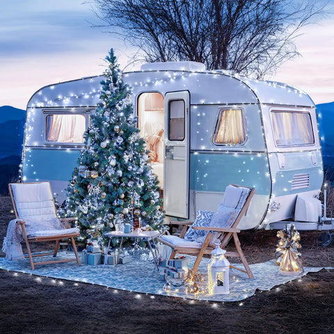 Festively lit vintage trailer with Christmas tree, using 2 Pack Outdoor Solar String Lights With 400 LEDs, 151 Feet, Waterproof.