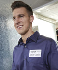 Top Shelf Name Badge Labels Compatible With Labelwriter Printers featuring a visitor's badge on a man in a purple shirt.