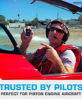 Pilot holding Fleet-Ready Carbon Monoxide Detector For Cars Planes Buses And Trucks With Fast Low-Level 9ppm Alarm in red cockpit