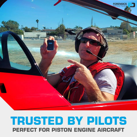 Pilot holding Fleet-Ready Carbon Monoxide Detector For Cars Planes Buses And Trucks With Fast Low-Level 9ppm Alarm in red cockpit