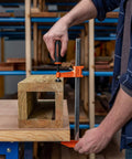 Twelve Inch Steel Bar Clamp With Instant Adjustment And Lightweight Orange Finish One Quarter Inch By Three Quarter Inch Spring Steel Bar Ideal Woodworking Clamp For Quick Grips And Grab And Go Setup on wood