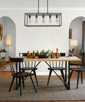 Modern Farmhouse Linear Chandelier In Matte Black For Kitchen Island And Dining Room above rustic dining table with candles.