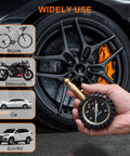 Close-up view of a hand-held tire pressure gauge with a 2-inch glowing dial beside a car wheel