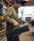 Slick Jhknnk Moisture Proof Welding Rod Storage Tube For Electrodes With Locking Lid held by a welder in a workshop.