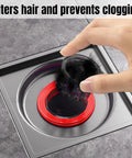 Hand removing debris from Odor Proof Floor Drain With Anti Odor Shield for Bathrooms and Kitchens Backflow Prevention Odor Dispersion Control Debris Catcher Fits 1.5 To 2 Inch Caliber Rust Resistant ABS And Silicone Magnetic Suspension Tech.